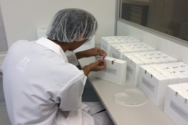 A man in a lab coat conducting topical drug product testing.