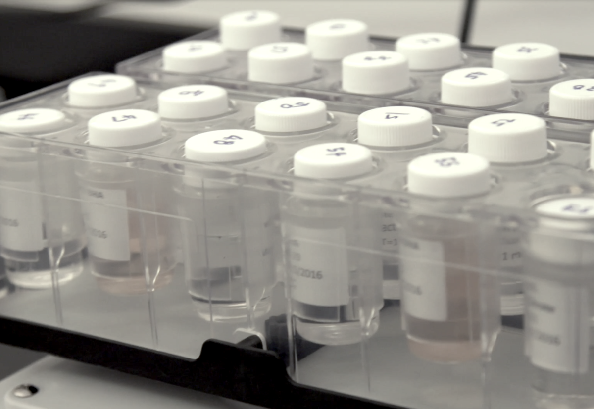 A tray of test tubes used in topical drug product testing in a laboratory.