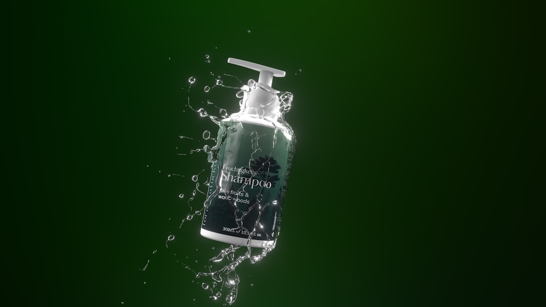 A bottle of shampoo with a pump dispenser is surrounded by splashing water, set against a plain green background—ideal for showcasing gels or creams in a stability study strategy.
