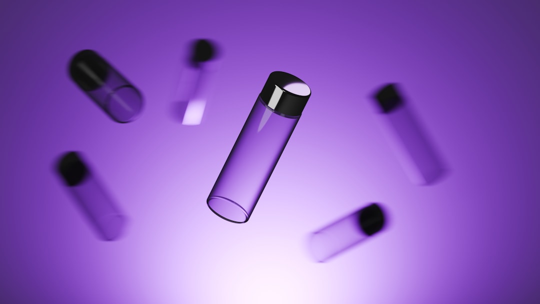 Five transparent cylindrical bottles with black caps, showcasing pharma packaging innovation, are floating against a purple gradient background.